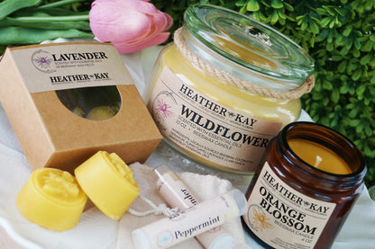 Non-Toxic Beeswax Candles, Aromatherapy Beeswax Wax Melts, and Natural Beeswax Lip Balm all together on a white tray display
